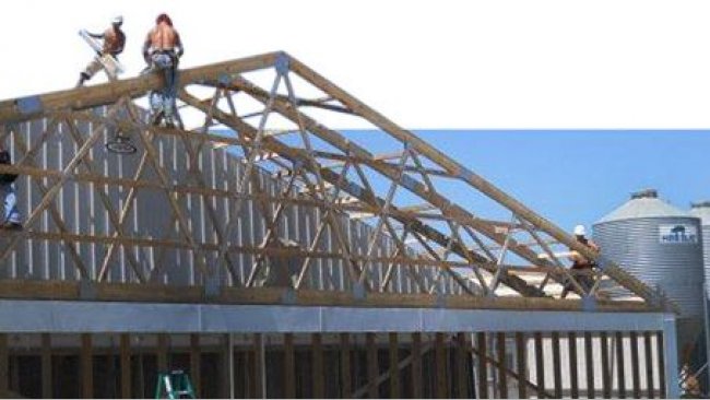 Construction work on a sow facility. Retrofitting an existing structure with a bank of air filter panels for a tunnel ventilated system. Picture courtesy by Perry Hartmann