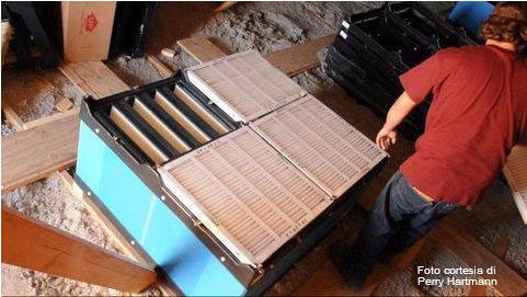 Installation of air filters and pre-filters over the inlets of an attic ventilated sow farm. Picture courtesy by Perry Hartmann