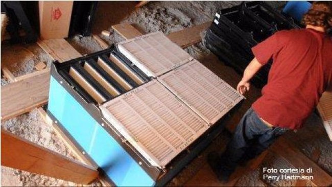 Installation of air filters and pre-filters over the inlets of an attic ventilated sow farm. Picture courtesy by Perry Hartmann
