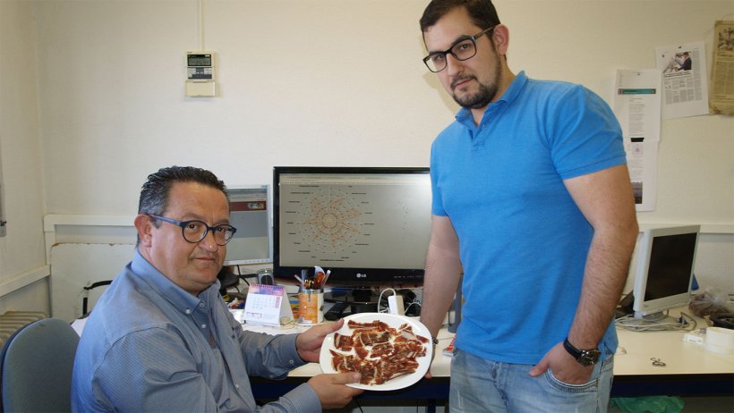 The researchers with a plate of ham.
