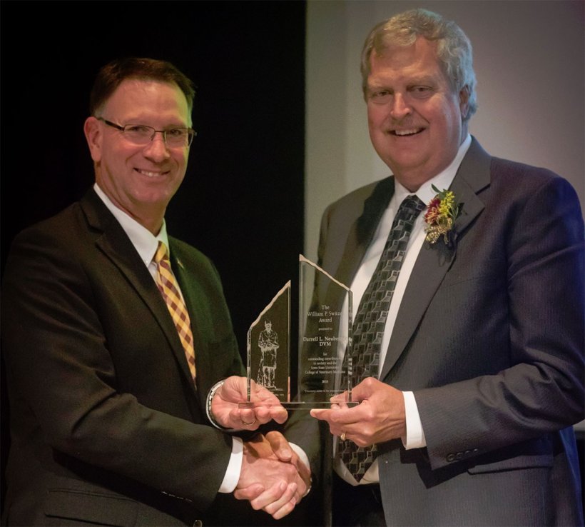 (Left to right) Dan Grooms, Ph.D., dean of the Iowa State University College of Veterinary Medicine, presents Darrell Neuberger, DVM, Tonisity technical services veterinarian, with the 2018 William P. Switzer Award in Veterinary Medicine for his contributions to society and to the college. (Photo credit: Iowa State University)
