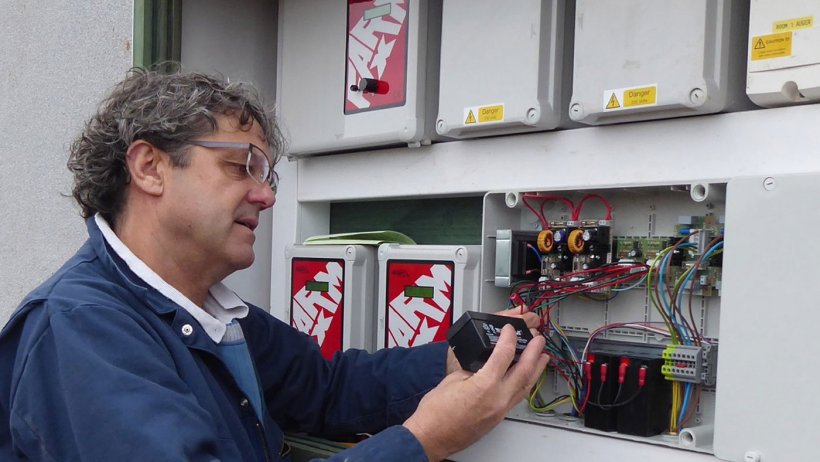 Tim Miller checks a fail-safe battery on a 400-pig place finishing building on a Midlands farm.