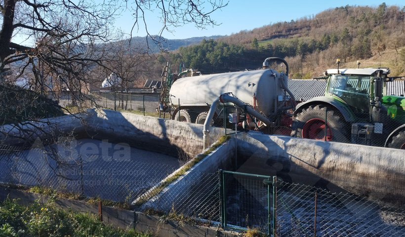 Slurry collection from a storage lagoon on a pig farm.
